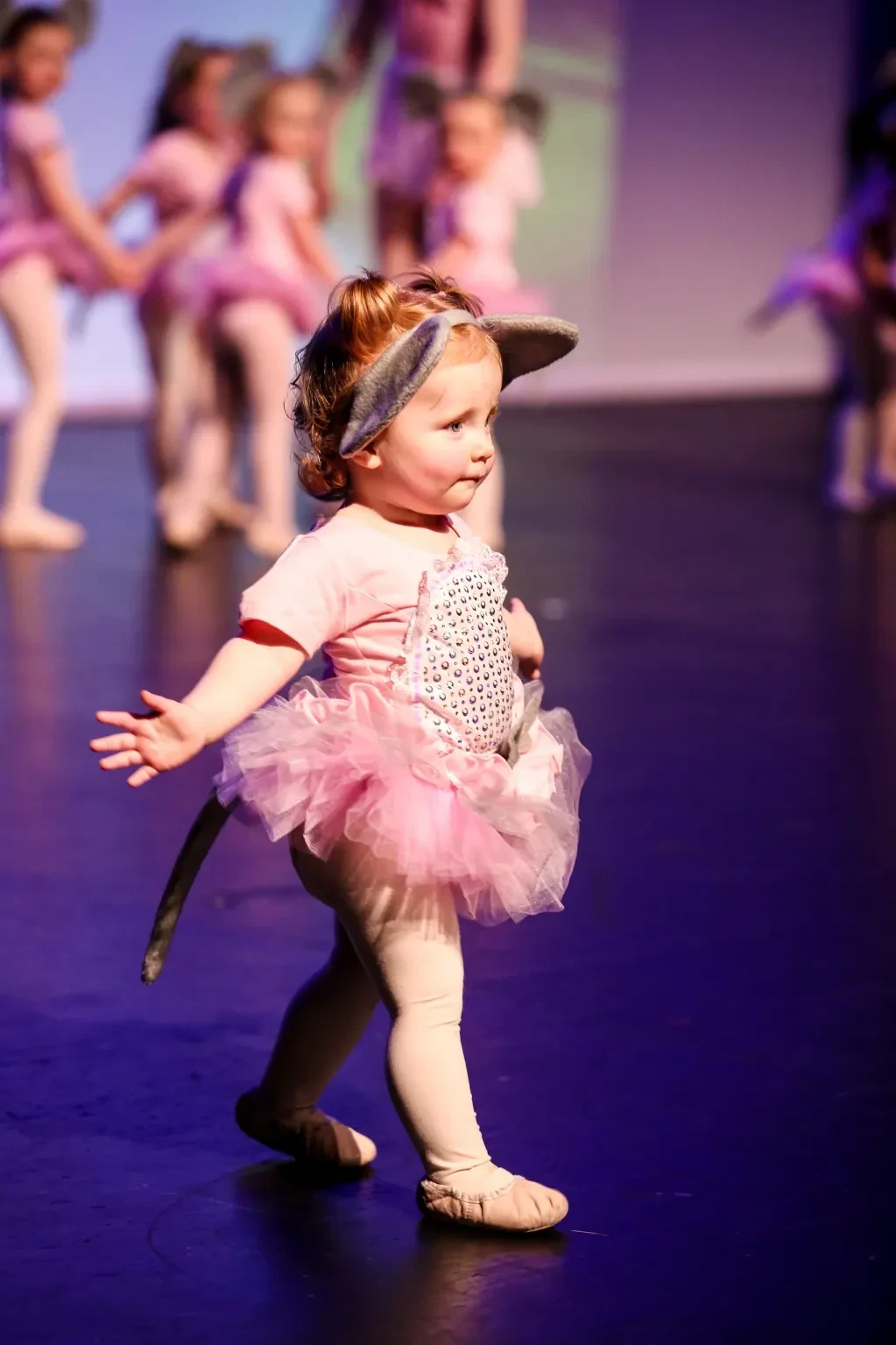 Young child performing ballet on stage
