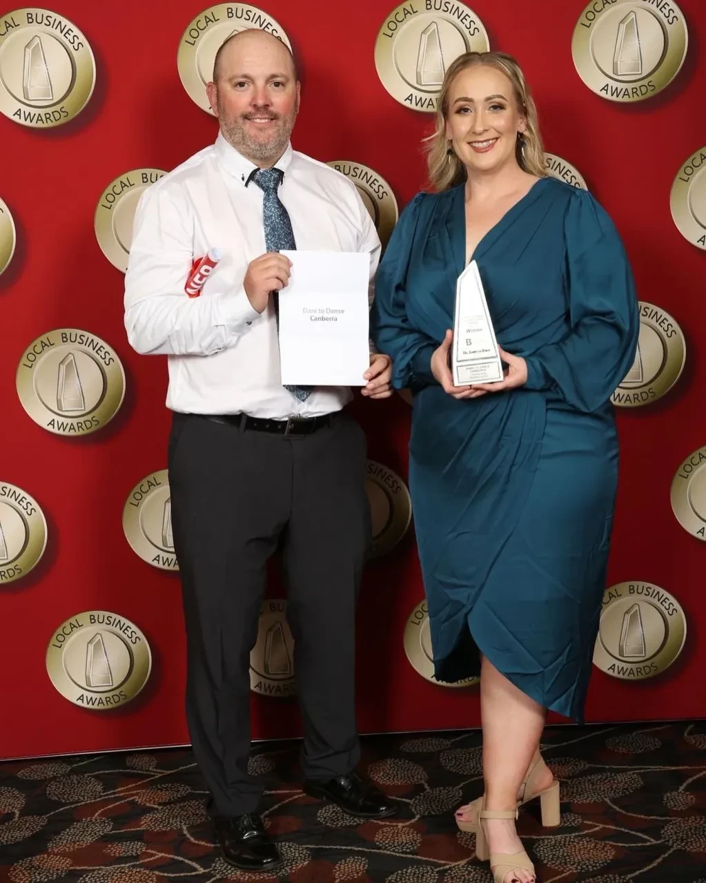 Dare to Dance Canberra representatives holding award and certificate at Local Business Awards red carpet